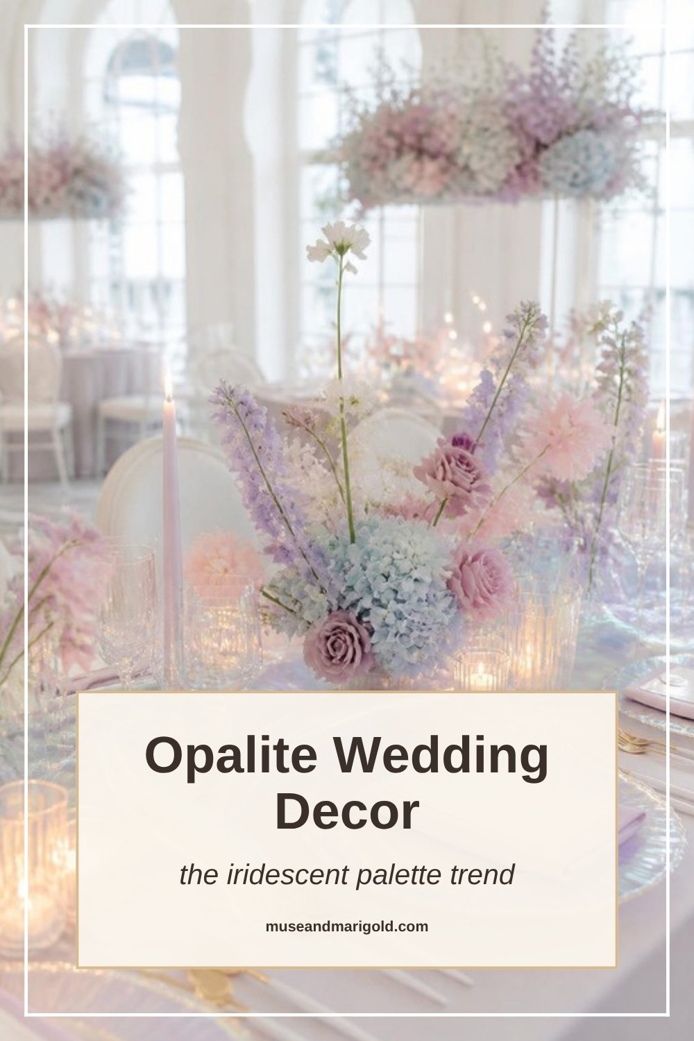 Iridescent pastel wedding centerpiece of lilac, blush and powder-blue flowers in a bright hall with tall arched windows