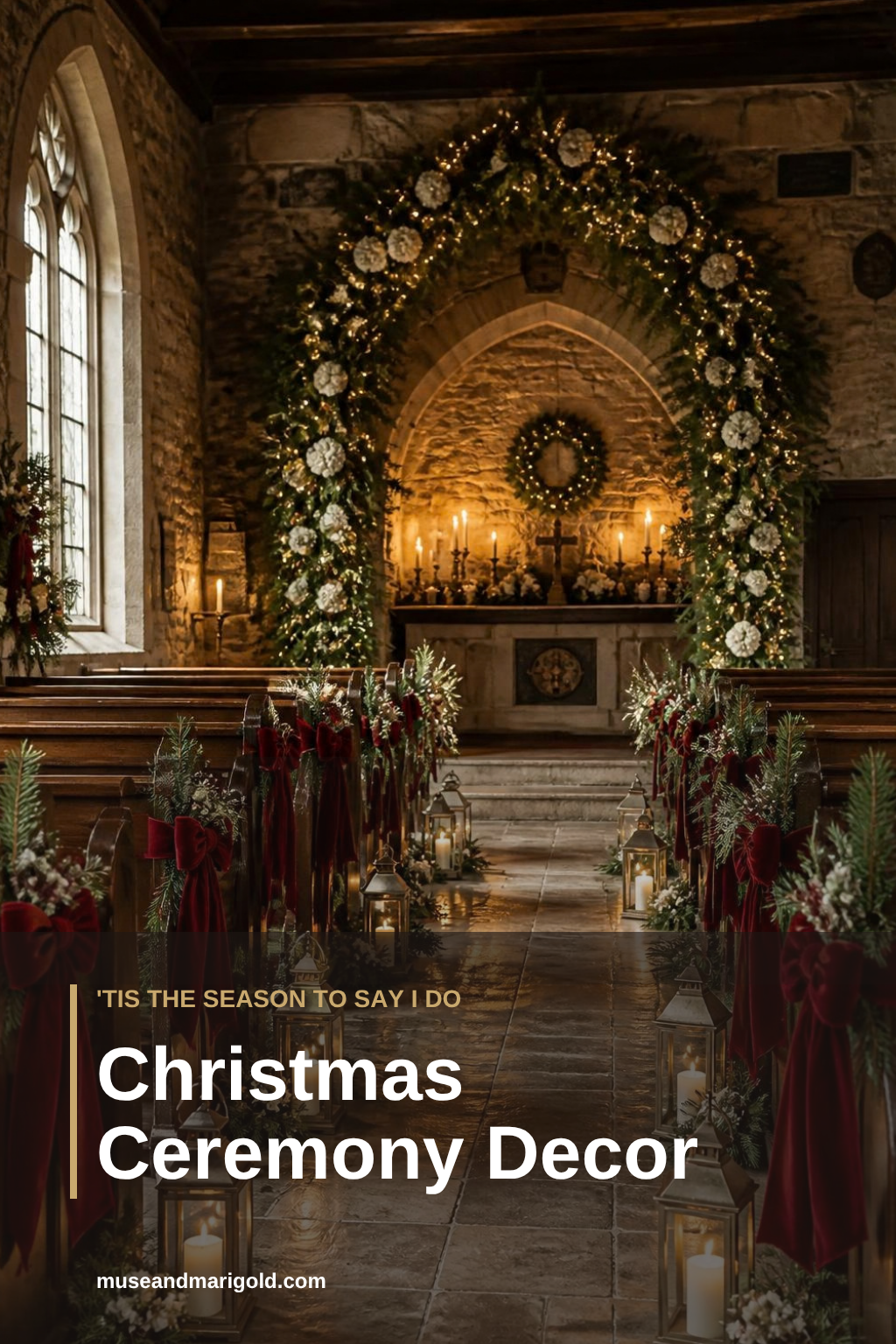 Candlelit stone chapel decorated for a Christmas wedding with an evergreen arch, lanterns and burgundy velvet pew bows