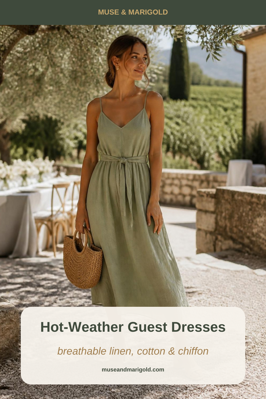 Wedding guest in a sage green linen midi dress with a raffia bag in a sunny vineyard courtyard