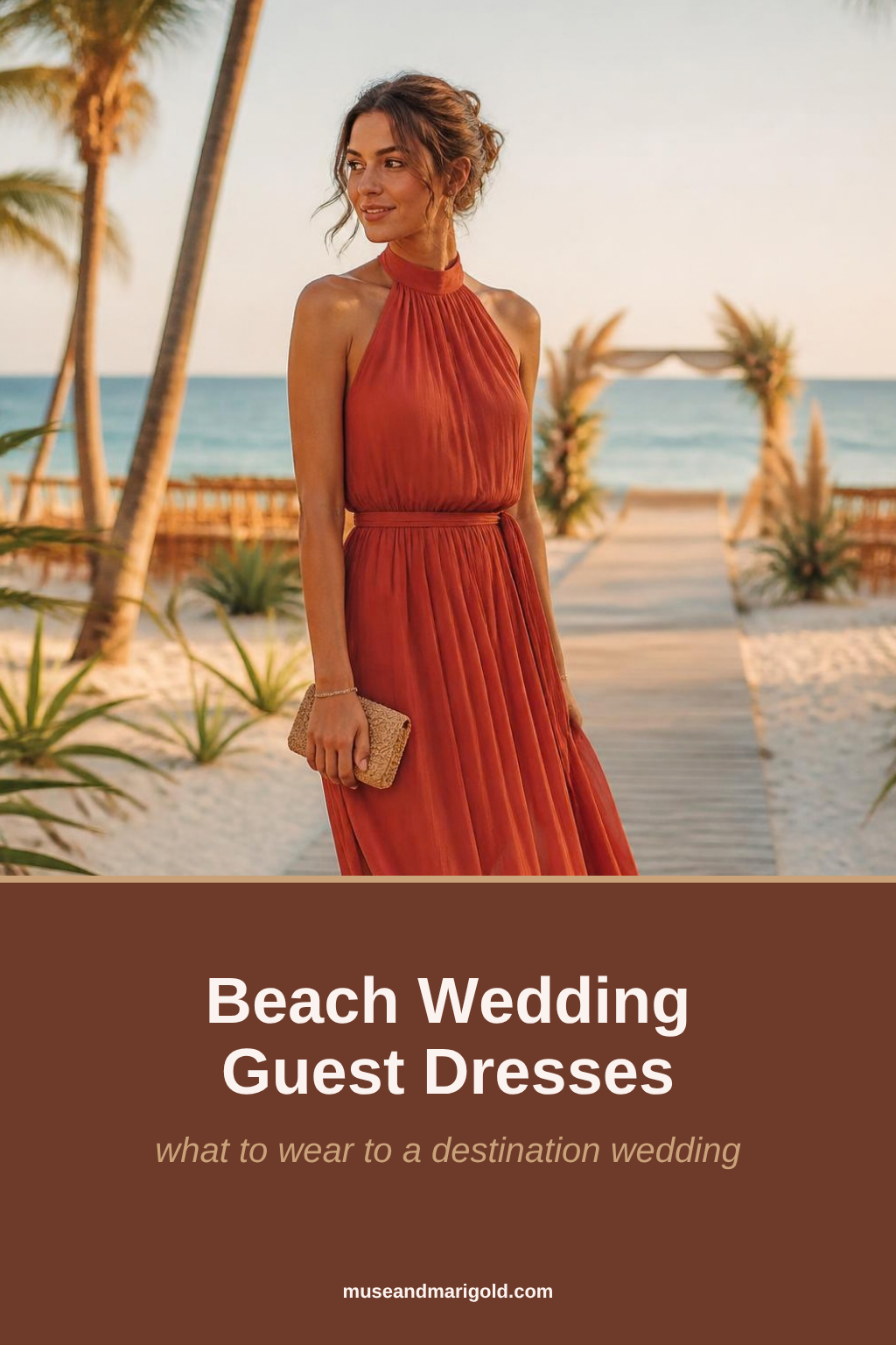 Wedding guest in a terracotta chiffon halter maxi dress on a beach boardwalk with palm trees at golden hour